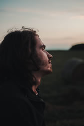 man looking down into crevice