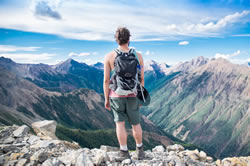 young hiker looking over the mountains, considering his destiny