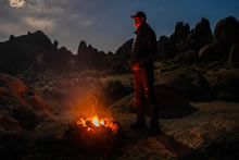 man looking across fire