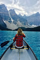 young lady steering a canoe