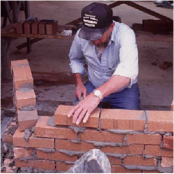 man laying brick